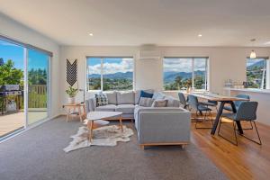 a living room with a couch and a table at Tipi Haere in Nelson