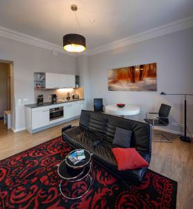 a living room with a couch and a table at Amalienhof Serviced Apartments in Weimar