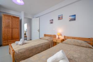 Posteľ alebo postele v izbe v ubytovaní NAXOS HOUSE