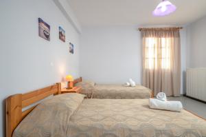 Posteľ alebo postele v izbe v ubytovaní NAXOS HOUSE