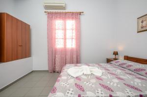 Posteľ alebo postele v izbe v ubytovaní NAXOS HOUSE