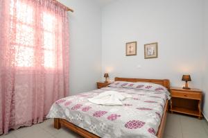 Posteľ alebo postele v izbe v ubytovaní NAXOS HOUSE