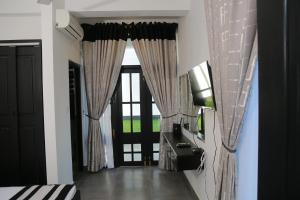 a hallway with curtains and a large window at 3R Resort in Negombo