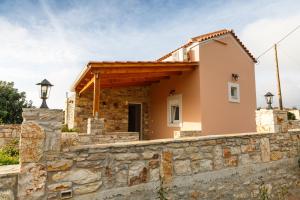 a house with a stone wall at Villa Maria Kythera in Katsoulliánika