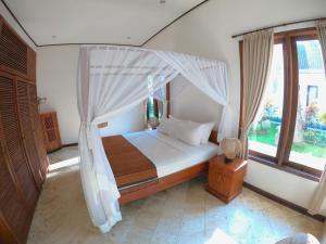 Postel nebo postele na pokoji v ubytování Agung Bali Nirwana Villas and Spa