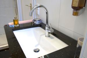 a bathroom sink with a faucet on a counter at Gästehaus Hebinger am Schlosspark in Deidesheim