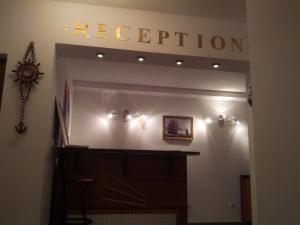 a reception room with a sign that reads reception at Byala Perla Family Hotel in Byala +28 photos