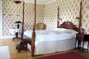 1 dormitorio con 1 cama y 1 mesa con lámpara en Boråkra Bed & Breakfast, en Karlskrona