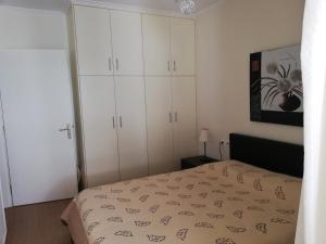 a bedroom with white cabinets and a bed at Efi Apartment in Paralio Astros