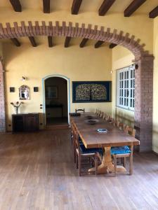 a large dining room with a wooden table and chairs at Villa Bonelli Bed & Fest in Savigliano