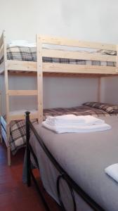 two bunk beds in a room with a bed at B&B Bucaneve in Abetone