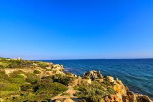 a view of the ocean from a rocky coastline at Bayside Salgados in Albufeira
