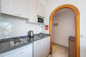 A kitchen or kitchenette at Apartamentos Es Cañe