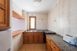 A kitchen or kitchenette at Apartamentos Es Cañe