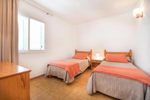 A bed or beds in a room at Apartamentos Es Cañe
