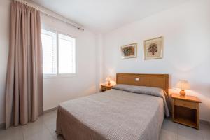 A bed or beds in a room at Apartamentos Es Cañe