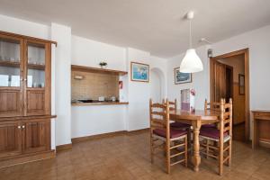 A kitchen or kitchenette at Apartamentos Es Cañe