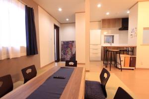 a living room with a table and chairs and a kitchen at NY Stage 新宿 in Tokyo
