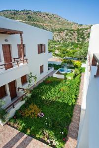 a view from the balcony of a building with a garden at Syia Hotel in Sougia
