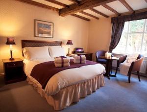 A bed or beds in a room at The Jacobean Hotel