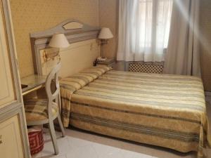 Postel nebo postele na pokoji v ubytování Hotel Falier