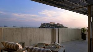 a balcony with a view of a castle on a hill at NJV Athens Plaza in Athens