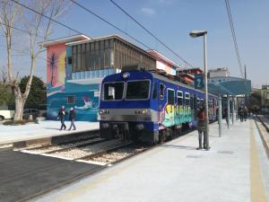 a blue train is parked at a train station at Hotel Nuvò in Naples