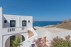 a view of white buildings and the ocean at Yalos rooms in Astypalaia Town