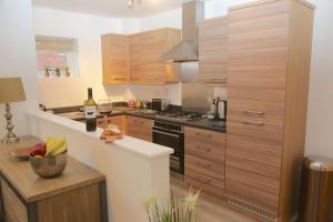 a kitchen with wooden cabinets and a counter top at Wilford View in Nottingham