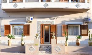 a house with windows and plants in front of it at DolceLina Home in Lampedusa