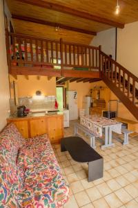 a living room with a bed and a staircase at Hameau 516 in Aureilhan