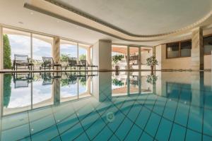 a swimming pool with a view of a building at Landsitz Stroblhof in Tirolo