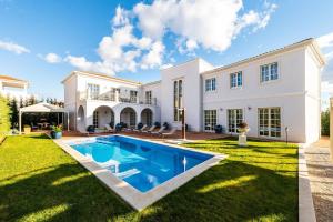 a large white house with a swimming pool in the yard at Villa Zara in Vabriga