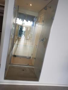 a glass elevator in a room with a person in the distance at ocean dune sibaya in La Mercy