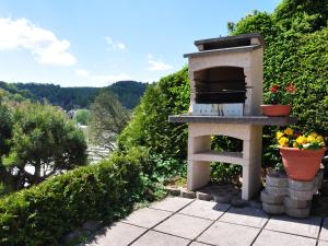 a outdoor oven with flowers in pots on a patio at Ferienwohnung Panorama in Schmalkalden