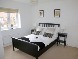 a bedroom with a black and white bed and a window at Wilford View in Nottingham