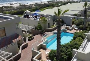 an aerial view of a house with a swimming pool at Dolphin Beach Apartment in Table View