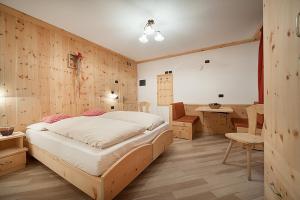 a bedroom with a bed and a desk in it at Chalet in Via Dali Mina in Livigno