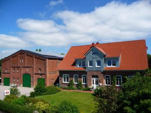 a large brick building with an orange roof at Meeresblick Fehmarn Ferienhaus 42 in Fehmarn