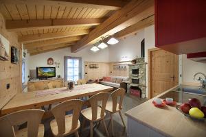 a kitchen with a table and chairs in a room at Chalet in Via Dali Mina in Livigno