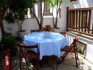 a table with a blue table cloth and two chairs at Dafni Studios in Neo Klima