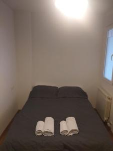 a bedroom with a bed with two towels on it at Apartamento Rio Lavilla in Castañares de Rioja