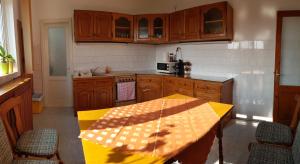 a kitchen with a yellow table and chairs in it at Premium Central Apartment in Oradea