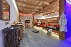 a bathroom with a couch and a dog in a room at Radauerhof in Castelrotto