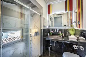 a bathroom with a sink and a mirror and a toilet at Arte' Boutique Hotel in Florence