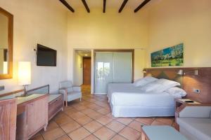 a hotel room with a bed and a television at Occidental Playa de Palma in Playa de Palma