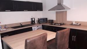 a kitchen with a wooden table and a stove top oven at domaine de la louvière in Le Clerjus