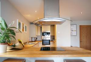a kitchen with a largeandelier hanging from the ceiling at Ocean Views 3 in Newquay