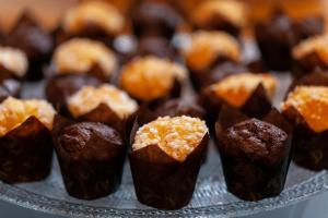 a tray of chocolate muffins on a plate at City Life Hotel Poliziano, by R Collection Hotels in Milan +40 photos