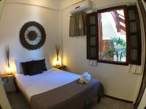 um quarto com uma cama e uma janela em Villa Guarani Jeri em Jericoacoara